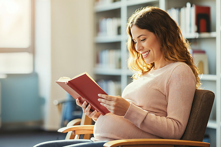 Pregnant woman reading a book