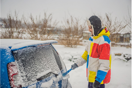 Removing snow from car with a brush, a Transportation Photo by Elizaveta Galitskaya
