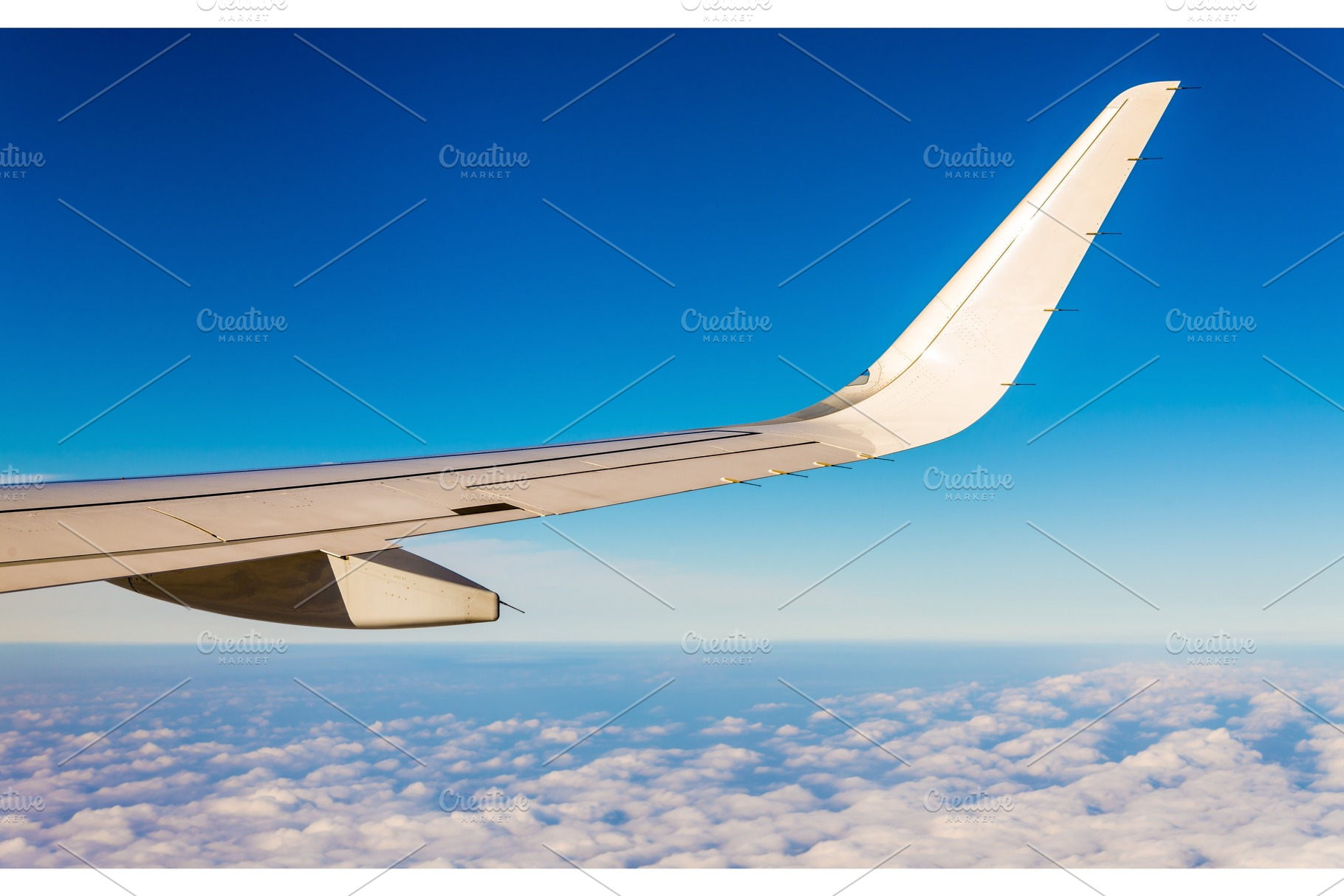 Aircraft wing flying over clouds, a Transportation Photo by Leonid Andronov