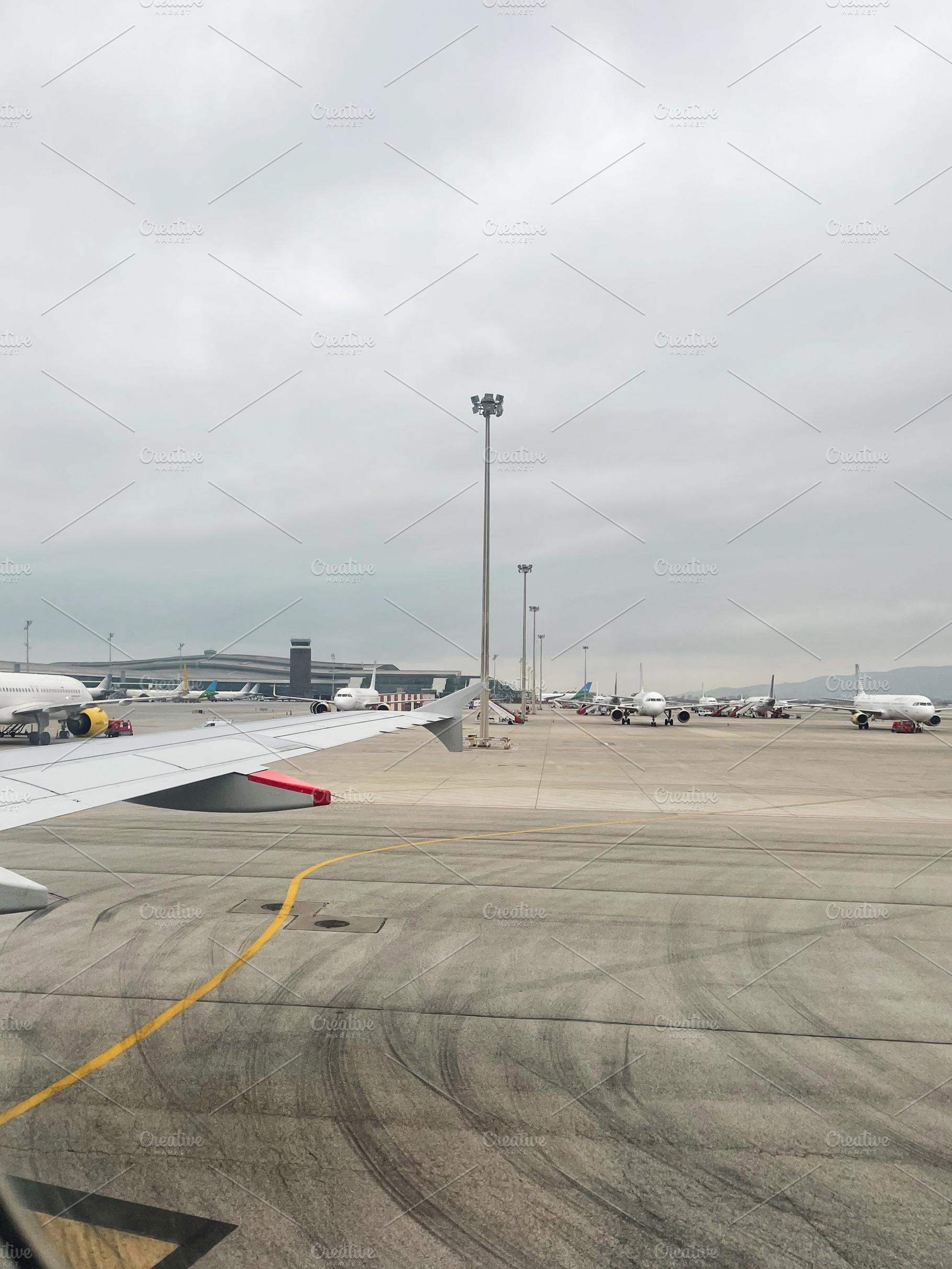 Aircraft parked on a cloudy day in airport runway in Spain, a Photo by AS photostudio