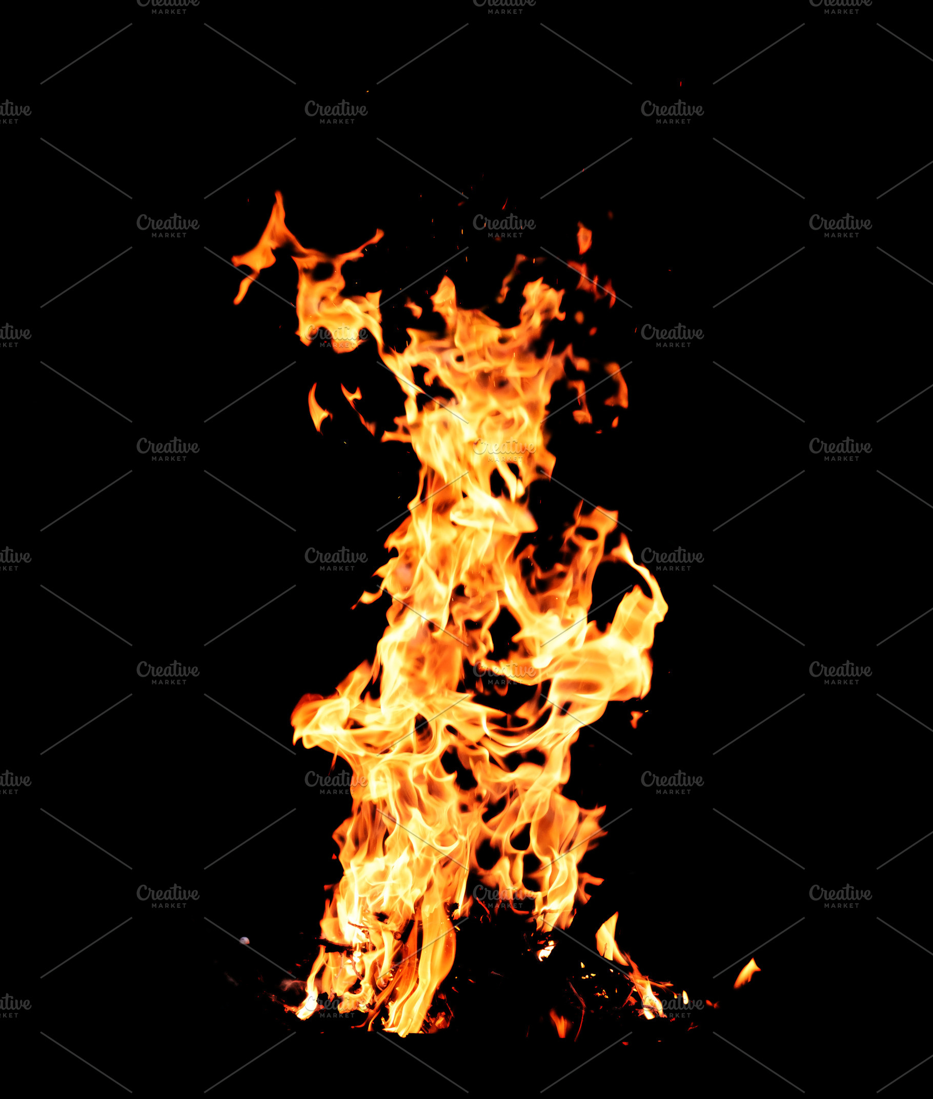 Intense tongues of orange and yellow flame, small glowing sparks, a Background Photo by ndanko