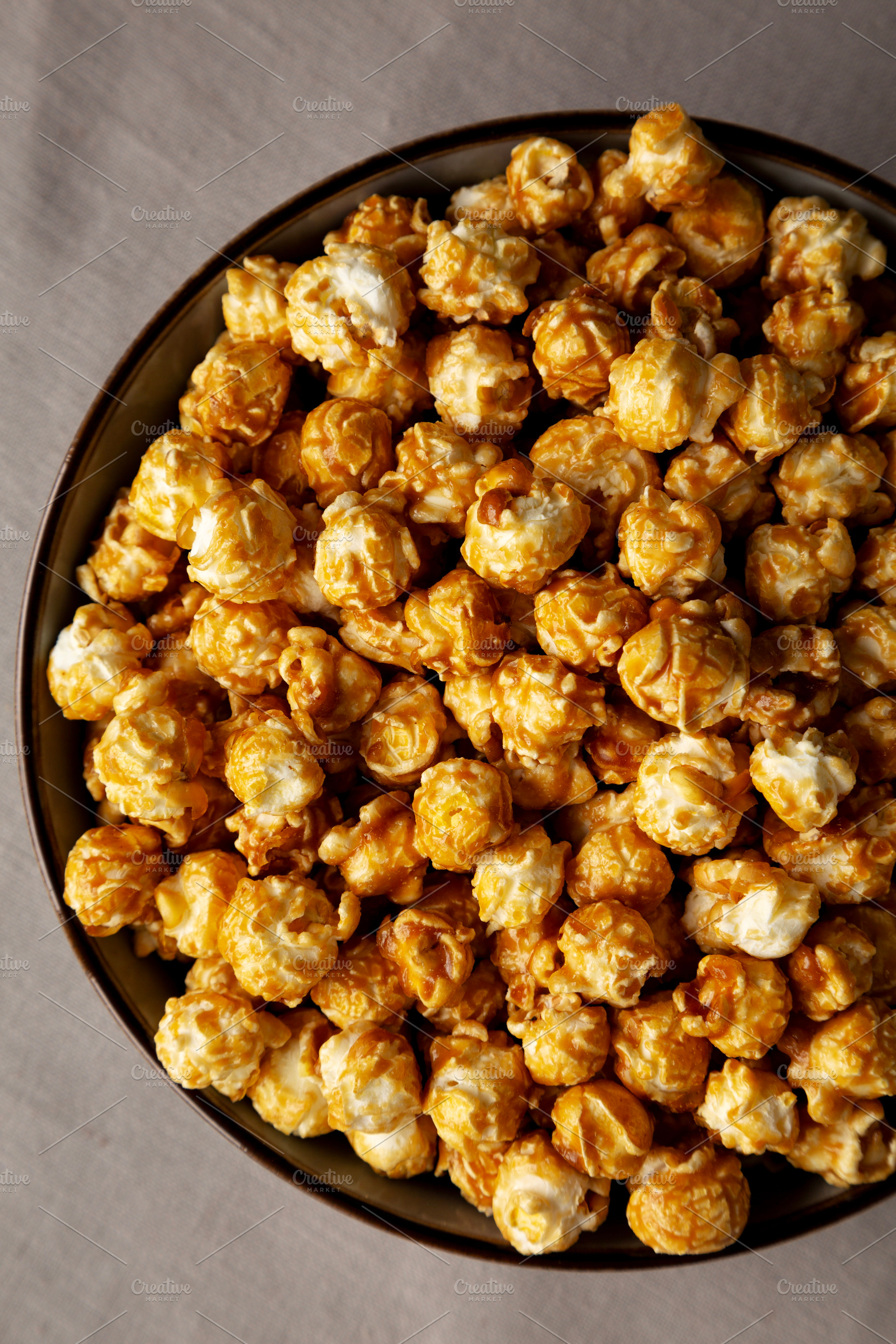 Homemade Caramel Pop Corn in a Bowl, top view., a Food & Drink Photo by LiudmylaChuhunova