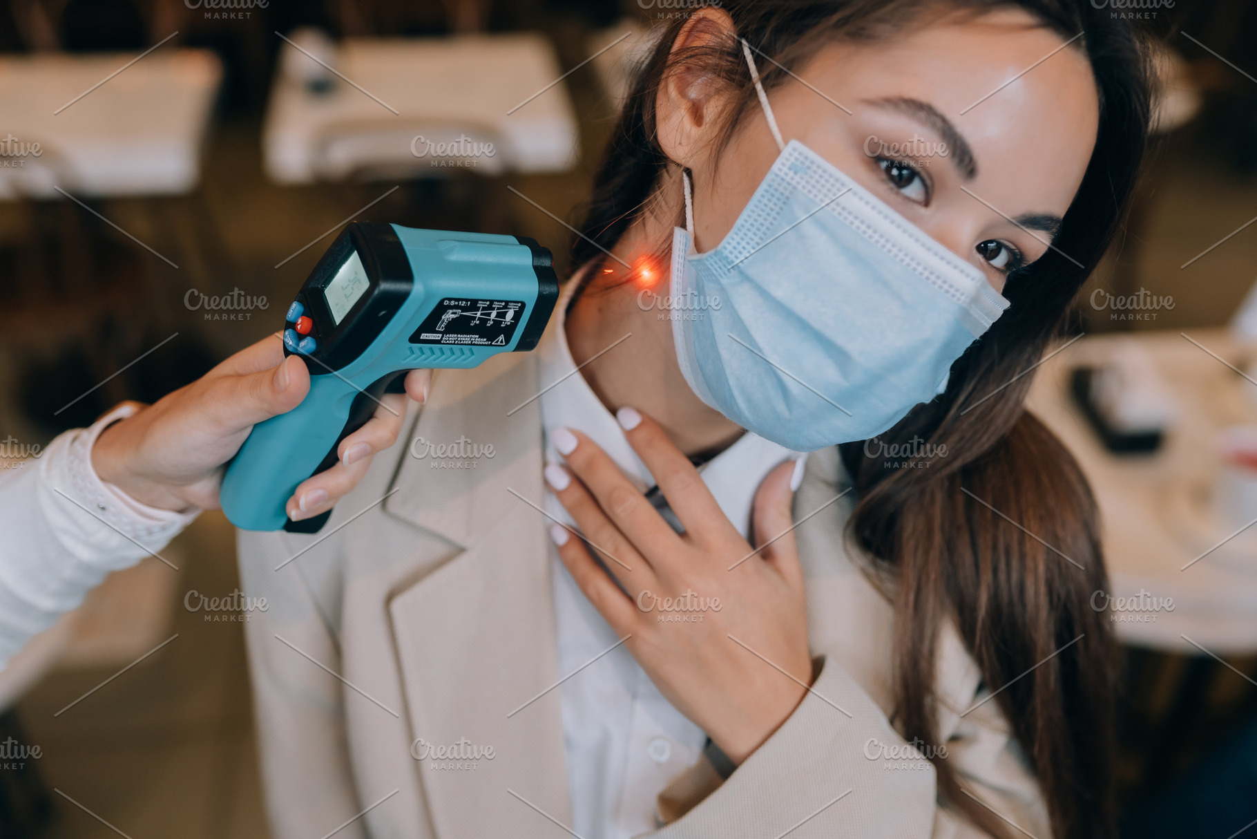 Measuring body temperature with contactless body thermometer, a Person Photo by Tekso