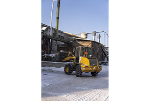 Yellow wheel loader filling bucket, an Industrial Photo by volodymyrshtun13795
