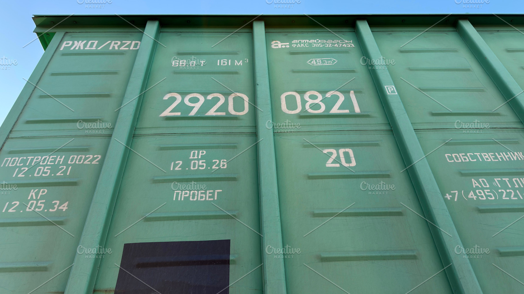 A close-up view of a green shipping container with various markings and numbers, an Industrial Photo by Textures & Backgrounds