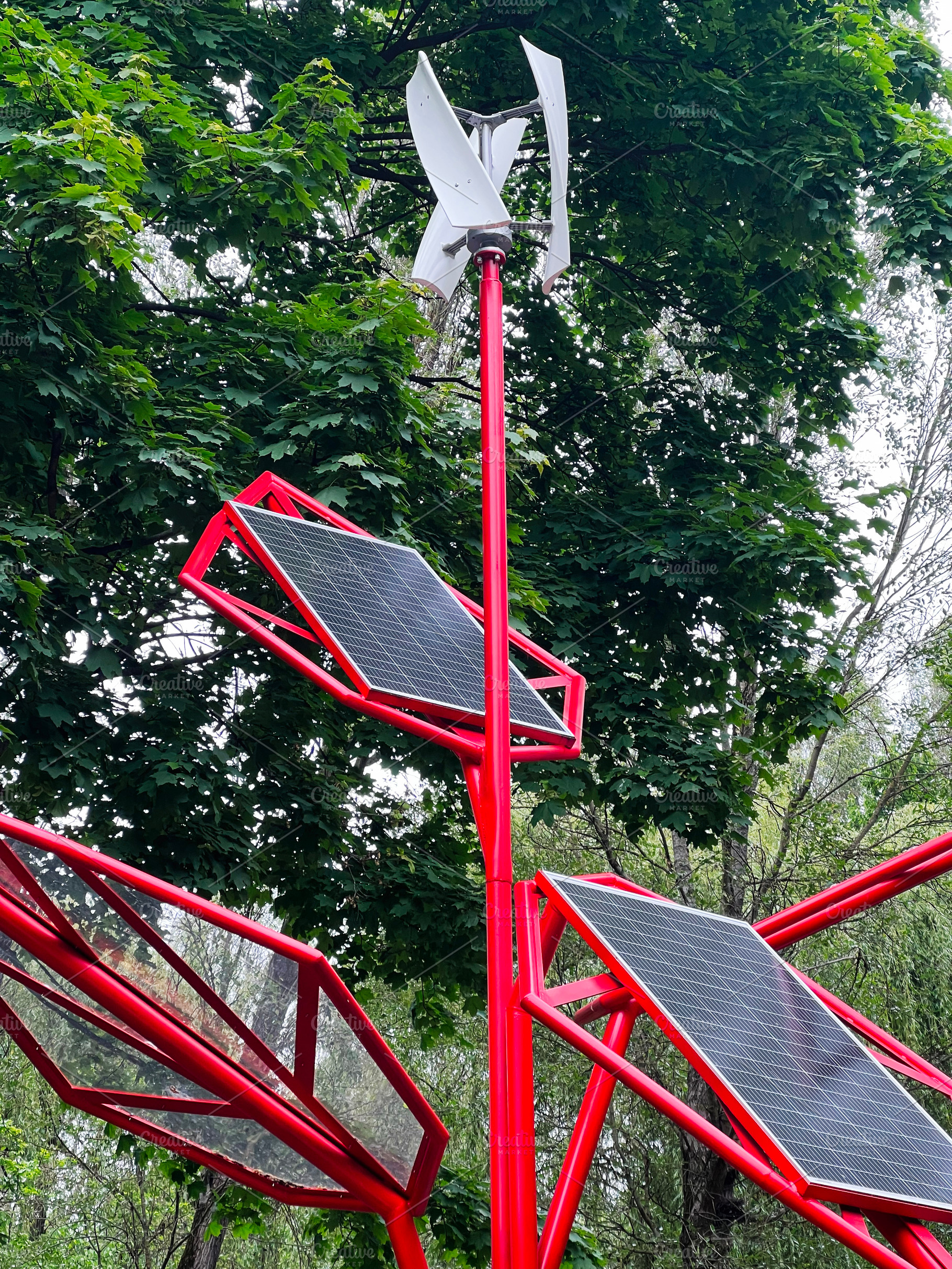 Red pole with solar panels and wind turbine in a green forest environment, a Photo by AS photostudio