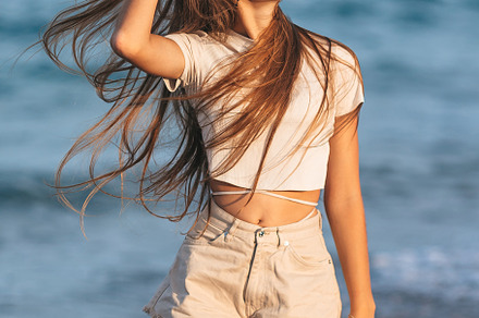 Adorable young girl with beautiful long hair enjoy tropical beach vacation. The, a Person Photo by travnikovstudio