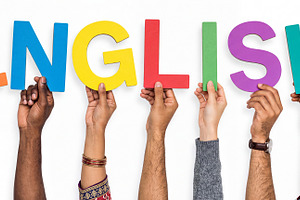 Diverse multiracial hands holding colorful cardboard letters for