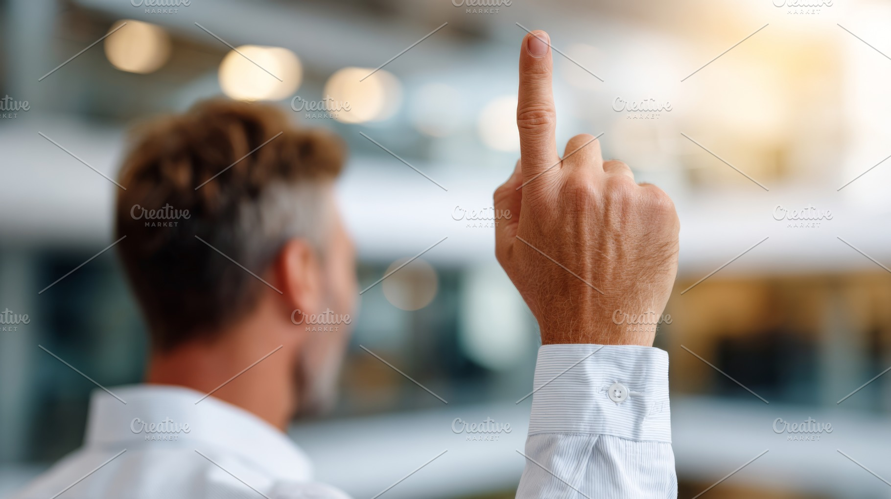A confident middle-aged Caucasian man raises his finger, signaling a bright ide, a Person Photo by ImageMir