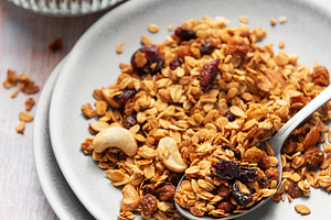 Healthy homemade granola mix on plate with spoon, a Food & Drink Photo by Olena Rudo