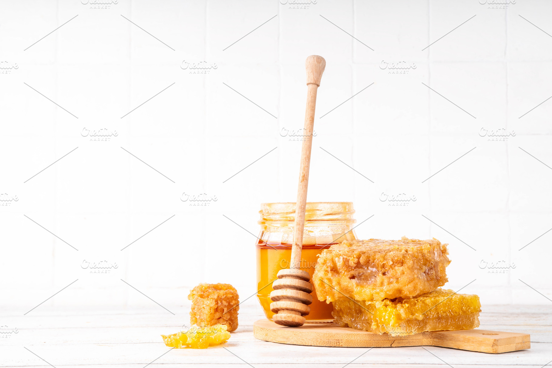 Golden flower honey in a small jar, with honey dipper and honeyc, a Food & Drink Photo by Rimma