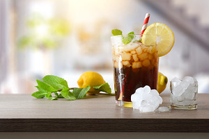 Refreshing cola drink with mint and lemon in living room, a Food & Drink Photo by Davizro's Market
