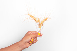 Close-up of a female hand with yellow nail polish holding a crys, a Food & Drink Photo by Ales Munt