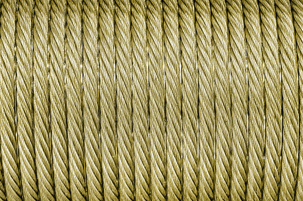 The texture of a new golden color cable wrapped in a spool. Abst, an Abstract Photo by Eugene_Photo