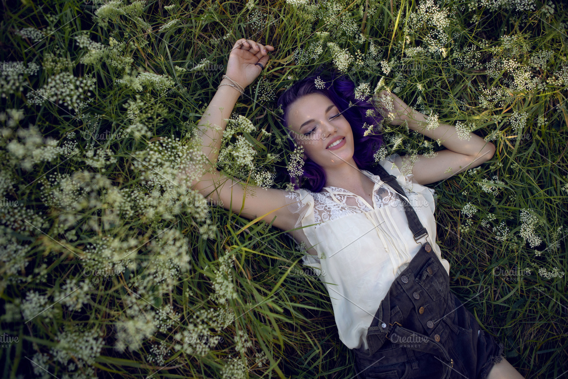 portrait of a teenage girl with purple hair and an earring in her nose lying in, a Person Photo by SaulichPhoto