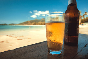 Sunny beach and beer glass