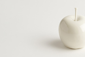 White ceramic apple on neutral background with minimalistic desi, a Photo by Dvoevnore photos