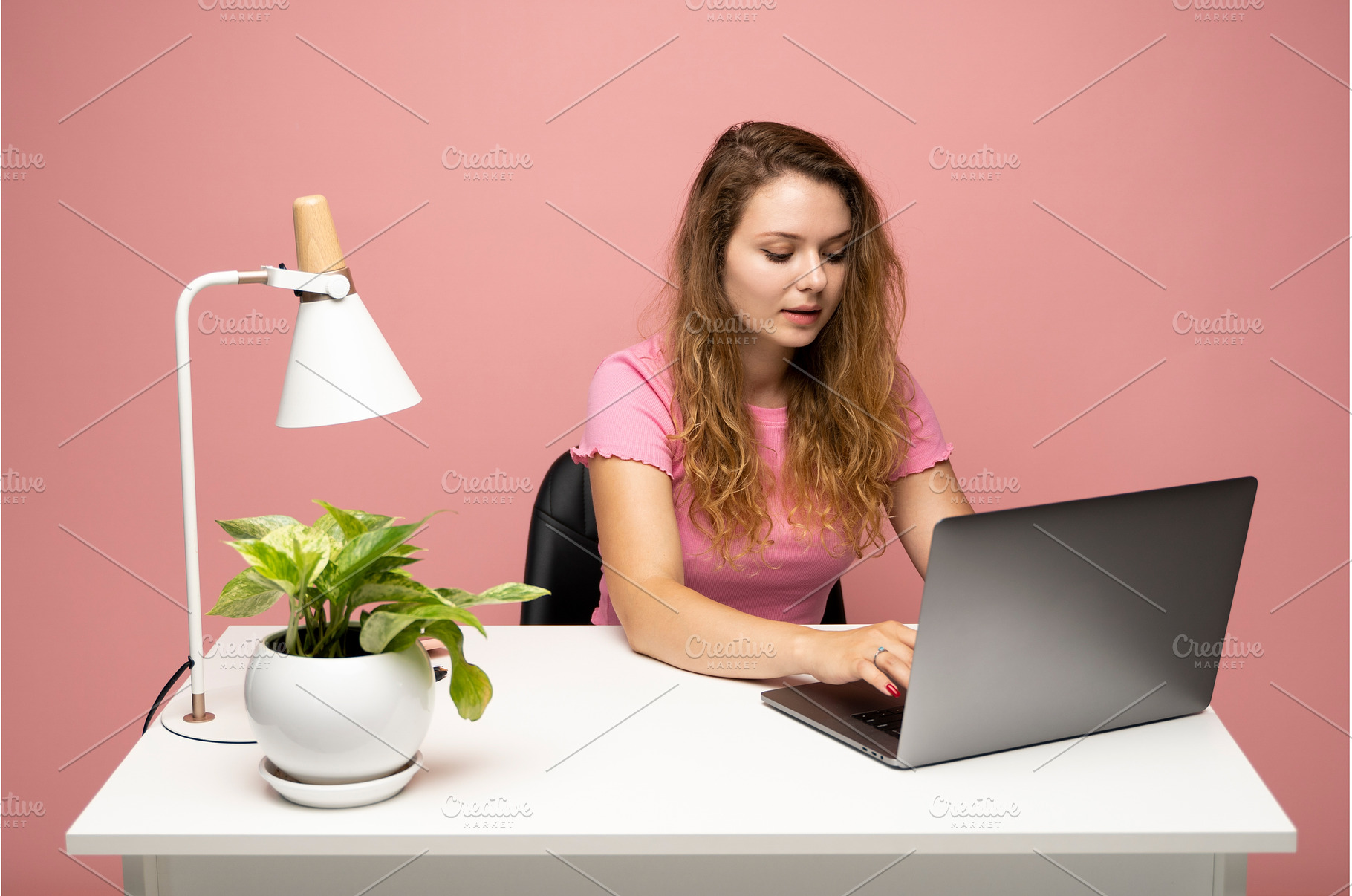 Woman working on laptop at white, a Person Photo by volodymyrshtun13795