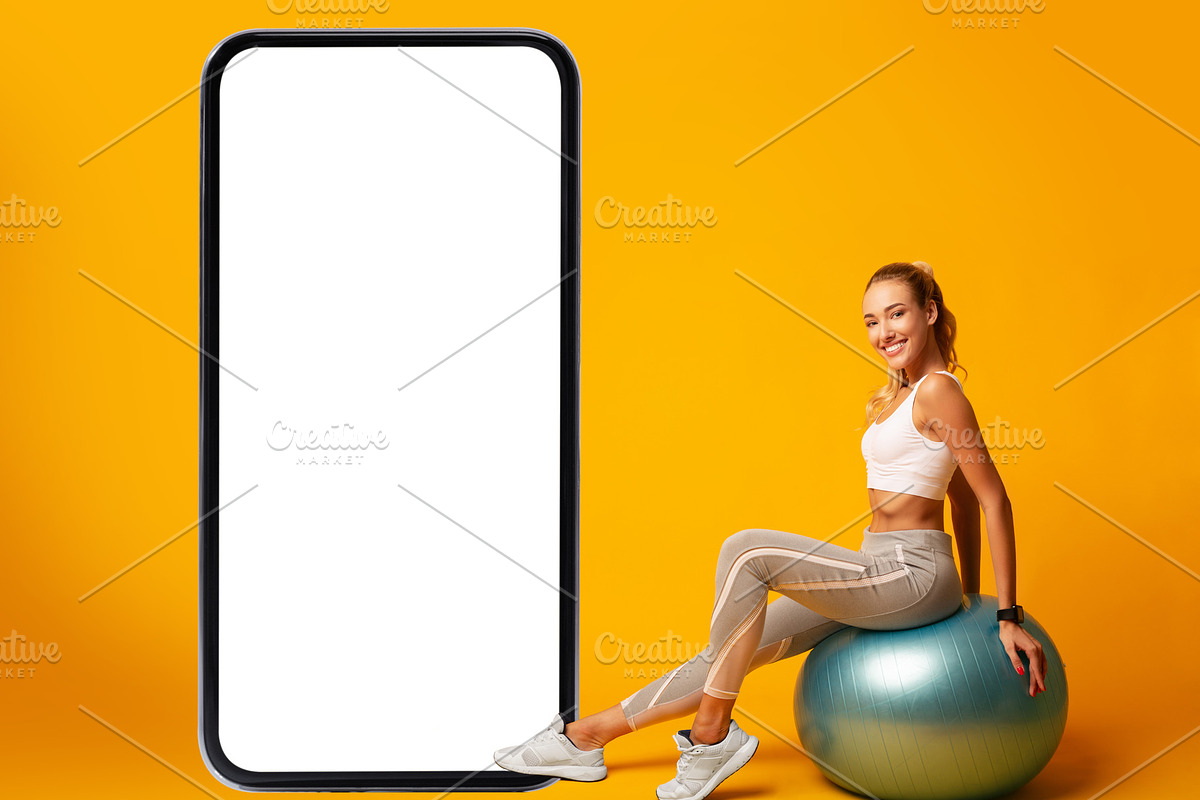Sporty Lady Sitting On Fitball Near Phone Screen, Yellow Background, a Photo by Prostock-Studio (Photo 4 of 8)