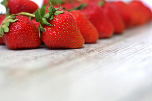 Strawberries on a gray wooden back, a Food & Drink Photo by Iryna Sotnykova