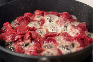 Chunks of raw beef are sizzling in a, a Food & Drink Photo by darksoul72