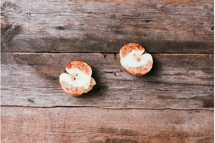 Spoiled bad red apple on wooden, a Food & Drink Photo by Enjoy Photo