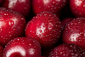 cherry in drops of water, wet cherry fruits on the kitchen table, a Photo by rsoollAI