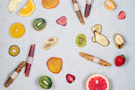 assorted ripe fruits and dried chips scattered on grey backgroun, a Food & Drink Photo by vimart