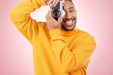 Portrait, man with a camera and smile for photography, taking a picture for art, travel or record of a happy memory. Creative photographer, happiness and shooting on retro or vintage film technology, a Photo by Peopleimages.com