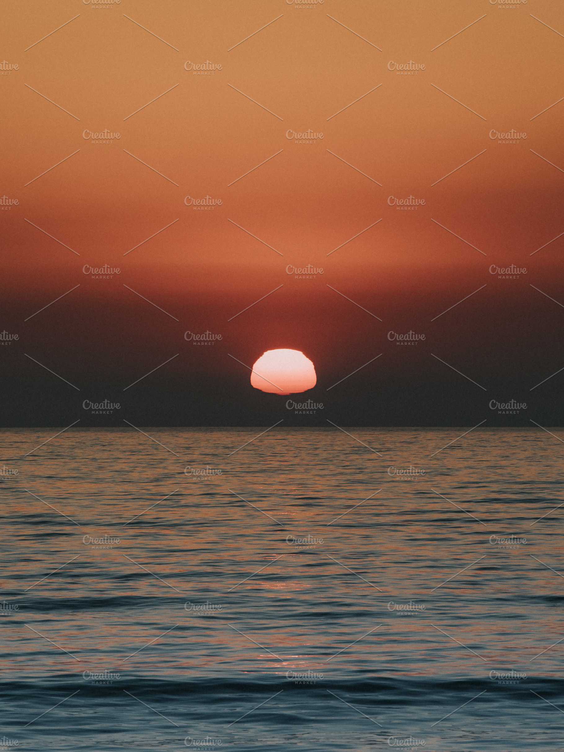 sun melting into the ocean, a Nature Photo by remi + tori
