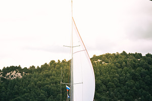 Sailboat under arch bridge on calm, a Photo by Dvoevnore photos