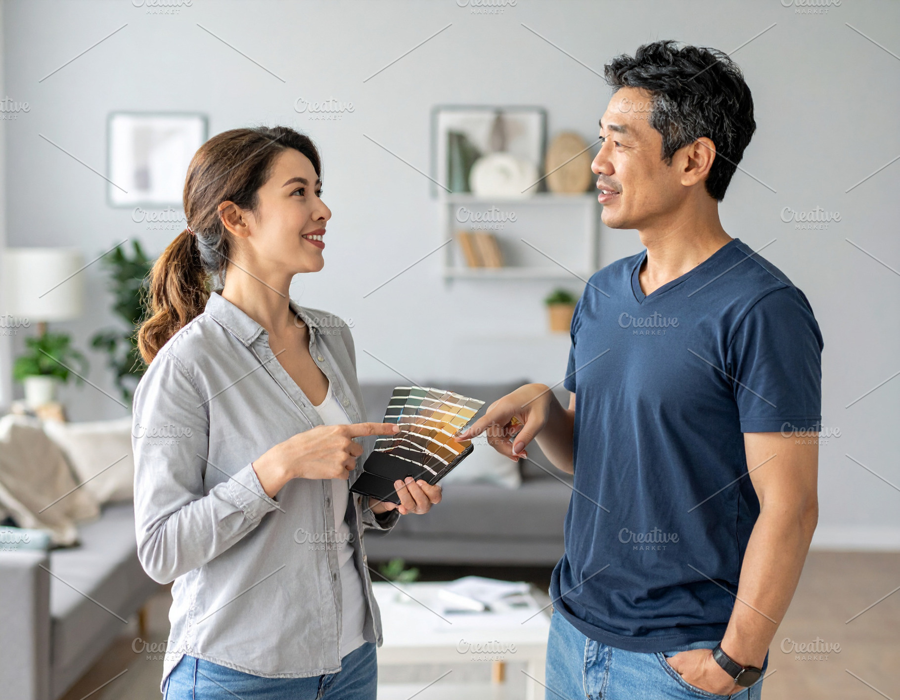 Interior decorators working together in a well lit home setting, a Person Photo by DanFLCreativo