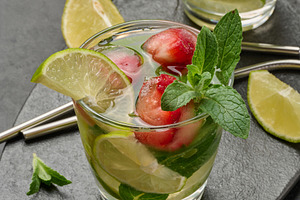 Refreshing mojito cocktail with lime, mint, strawberry, and ice, a Food & Drink Photo by ndanko