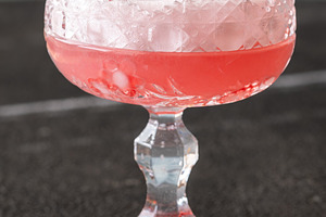 Elegant Clover Club cocktail with velvety foam fresh raspberries