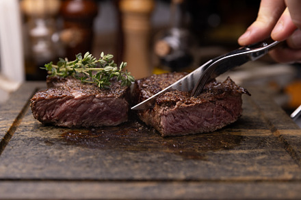 Steak on cutting board, garnished with fresh thyme, a Photo by Grafvision photography