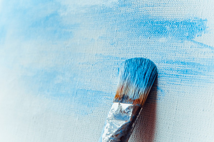 Paint brush on a painted canvas containing brushes, paints, and artist, an Arts & Entertainment Photo by Valeryia P.