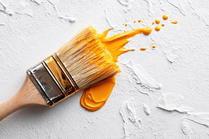 Bright yellow paintbrush on textured white surface, an Arts & Entertainment Photo by AlyaAnd