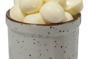 Round pieces of mozzarella in ceramic bowl, a Food & Drink Photo by ndanko