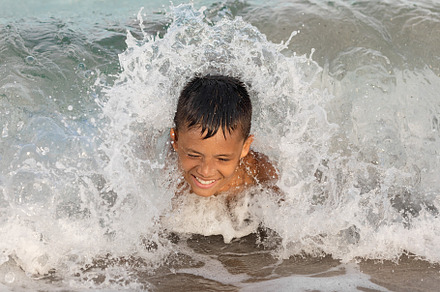 Young boy swimming in ocean