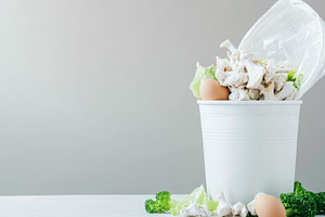 Food waste bin filled with chicken b, a Photo by Dvoevnore photos