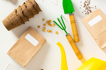Flat lay composition with garden tools, flower pots, gloves, paper bags with se
