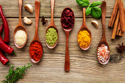 Various colorful herbs and spices on wooden table, a Food & Drink Photo by Olena Rudo
