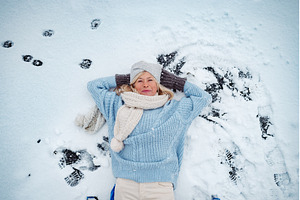 Older woman lying in show, enjoying, a Holiday Photo by HalfPoint