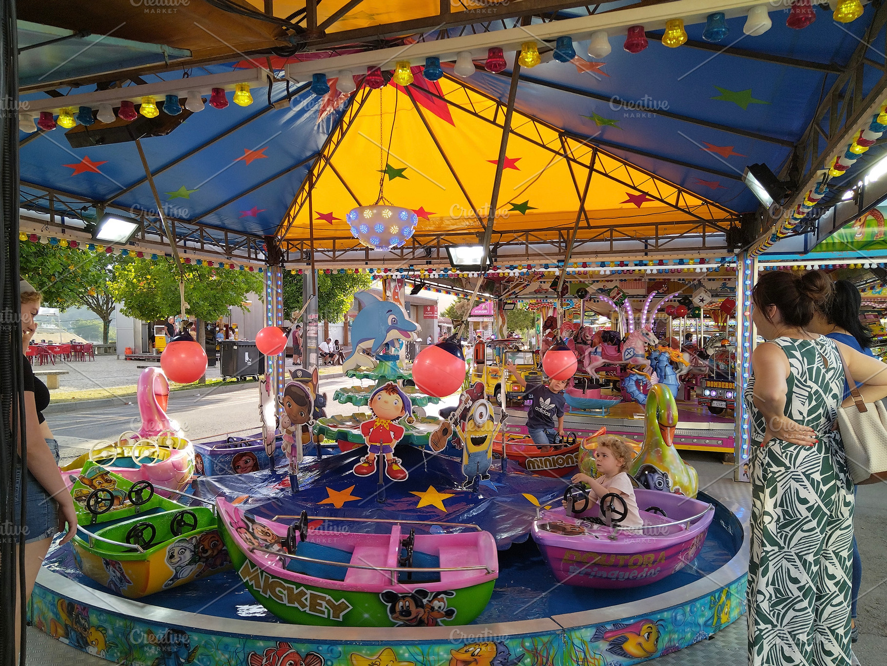 Mothers watching children at merry-go-round, an Arts & Entertainment Photo by DanFLCreativo