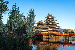 Matsumoto Castle and red bridge at sunset, Japan