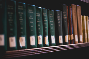 Books on a shelf containing bookshelf, book, and library