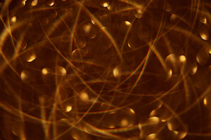Defocused glittering garland bokeh light golden, a Background Photo by Photo Drive Studio