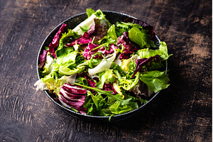 Bowl of fresh green salad mix, a Food & Drink Photo by Yulia Furman