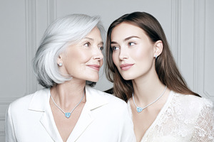 Two women, a senior mother and young adult daughter, sharing a l, a Photo by Studio ANNA