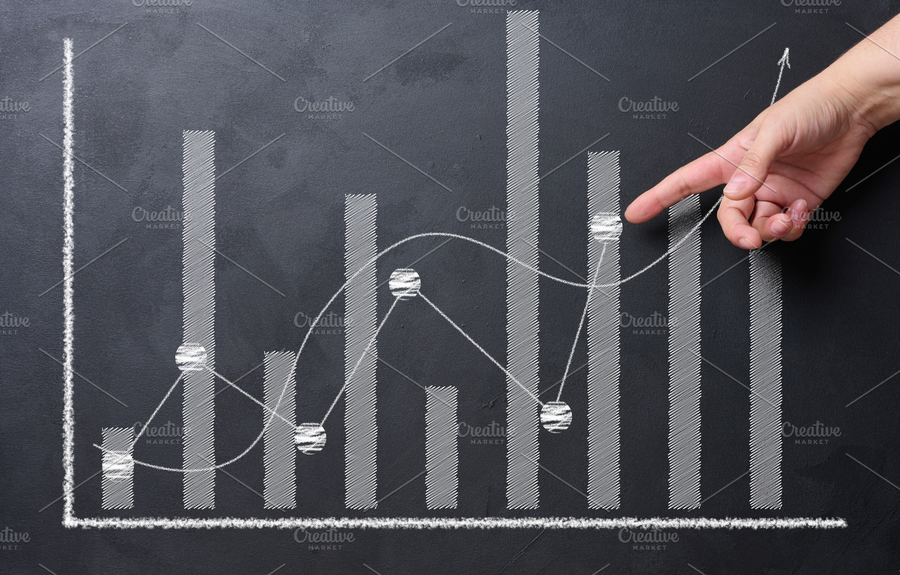 A hand reaches out towards a stock market chart drawn in white o, a Business Photo by ndanko
